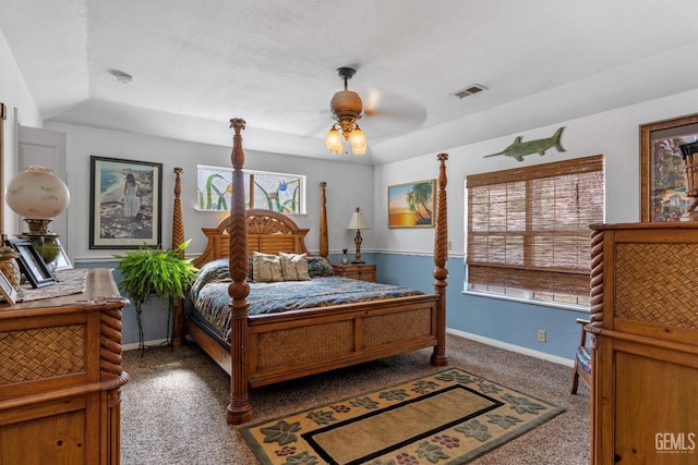 bedroom with dark colored carpet, a textured ceiling, and ceiling fan