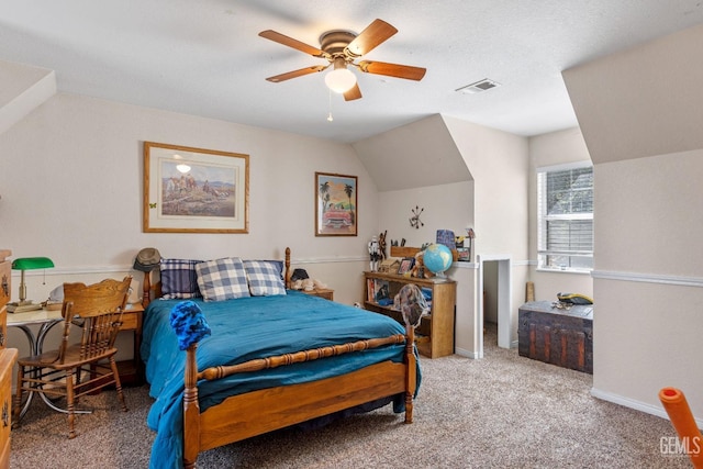 bedroom featuring carpet flooring, ceiling fan, lofted ceiling, and a textured ceiling