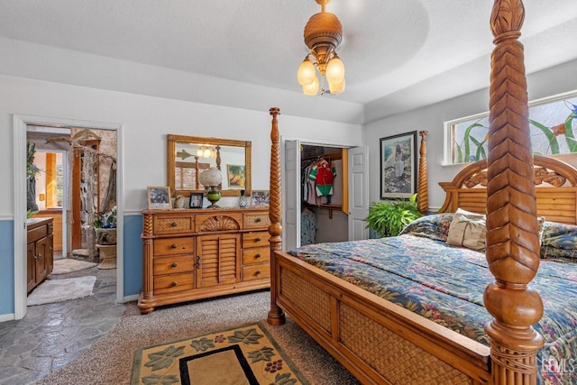 bedroom with carpet floors, ensuite bathroom, a closet, and ceiling fan