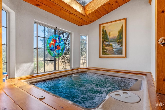 interior space featuring a skylight and an indoor hot tub