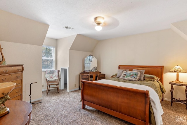 carpeted bedroom with a textured ceiling, ceiling fan, and lofted ceiling