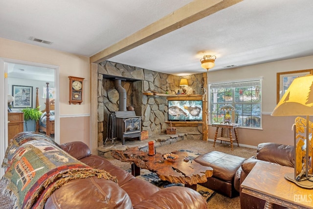 carpeted living room with a wood stove and a textured ceiling