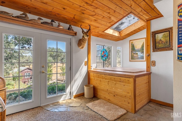 doorway with vaulted ceiling with skylight, wood ceiling, and french doors