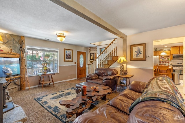 living room featuring carpet floors and a textured ceiling