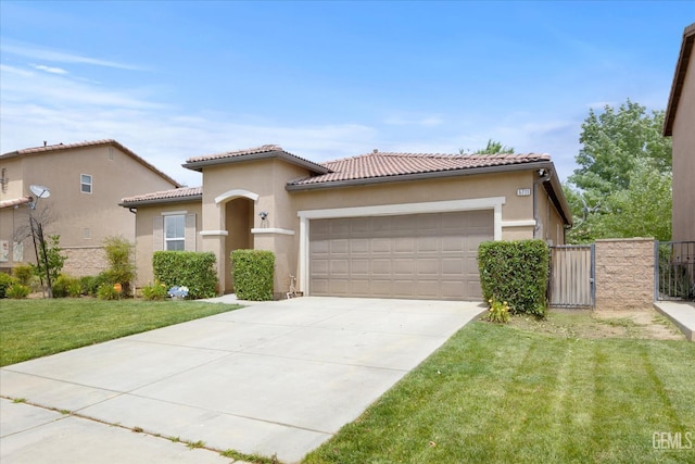 5711 Cordonata Way, Bakersfield, CA 93306 - mediterranean / spanish home with an attached garage, a front lawn, concrete driveway, a gate, and stucco siding