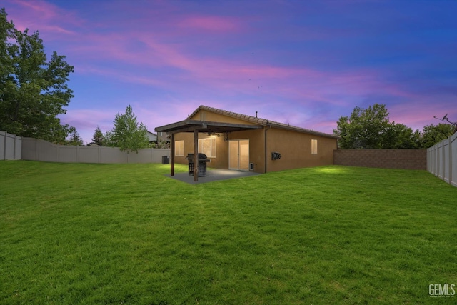 5711 Cordonata Way, Bakersfield, CA 93306 - back of property at dusk with a patio, stucco siding, a ceiling fan, cooling unit, and a tiled roof