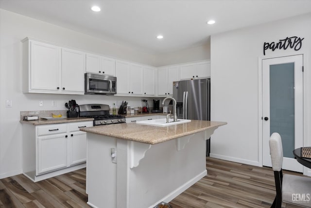 5711 Cordonata Way, Bakersfield, CA 93306 - kitchen with appliances with stainless steel finishes, wood finished floors, white cabinets, and recessed lighting