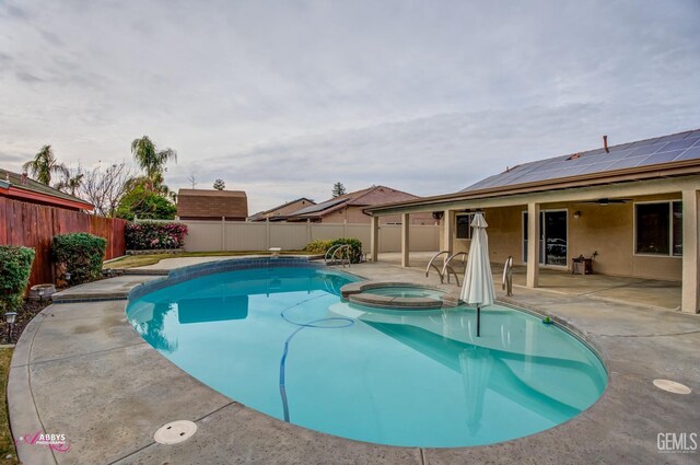 view of swimming pool with an in ground hot tub, a diving board, and a patio area