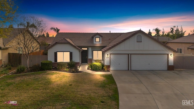 view of front of home featuring a lawn and a garage