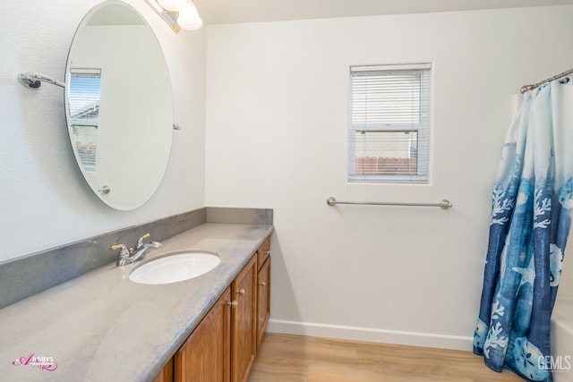 bathroom with hardwood / wood-style floors and vanity