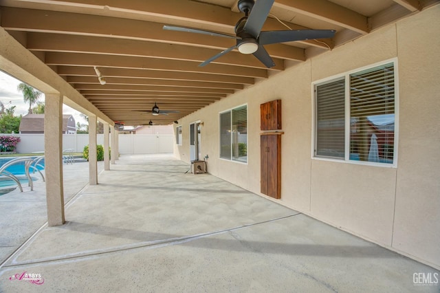 view of patio featuring a fenced in pool and ceiling fan