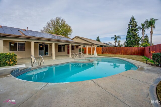 view of pool with an in ground hot tub and a patio