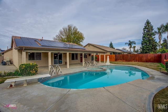 view of swimming pool featuring an in ground hot tub, a diving board, and a patio area