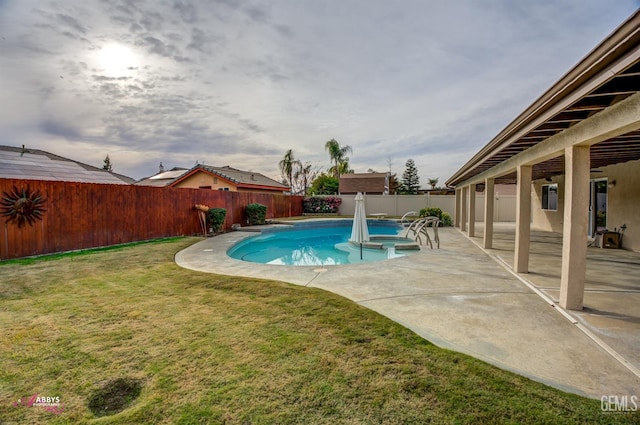 view of pool with a yard and a patio area