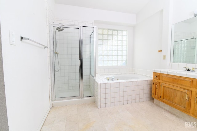 bathroom featuring tile patterned flooring, vanity, and independent shower and bath