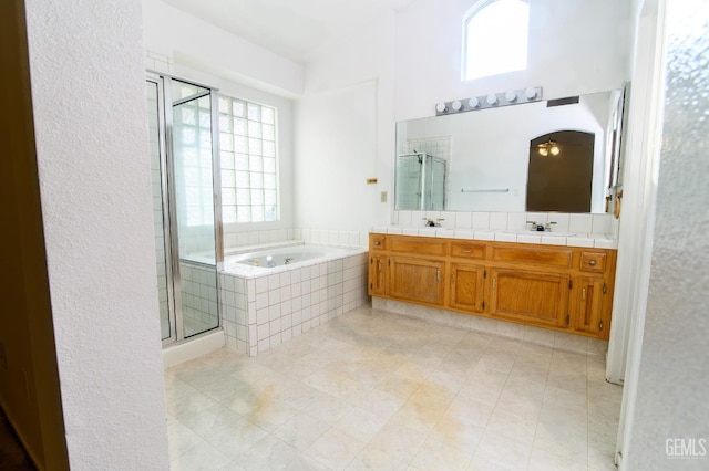 bathroom with tile patterned flooring, vanity, and independent shower and bath