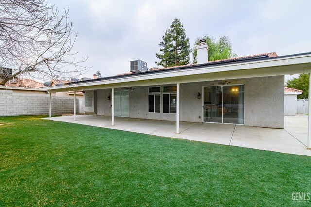 back of house with a patio area, ceiling fan, and a yard