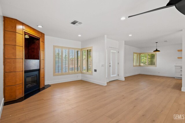 2330 Myrtle St, Bakersfield, CA 93301 - unfurnished living room with baseboards, a large fireplace, light wood-style flooring, and recessed lighting