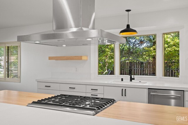 2330 Myrtle St, Bakersfield, CA 93301 - kitchen with island range hood, stainless steel appliances, light countertops, and plenty of natural light