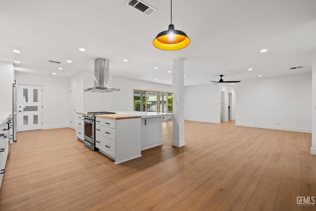 2330 Myrtle St, Bakersfield, CA 93301 - kitchen with ventilation hood, stainless steel stove, a ceiling fan, white cabinetry, and recessed lighting
