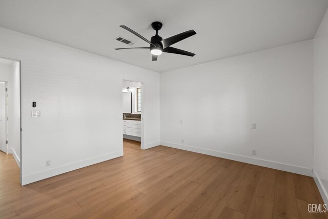 2330 Myrtle St, Bakersfield, CA 93301 - unfurnished bedroom featuring baseboards, light wood-type flooring, and ensuite bathroom