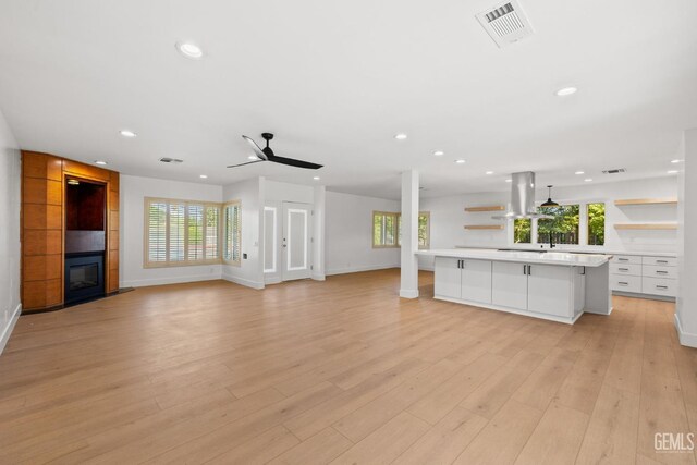 2330 Myrtle St, Bakersfield, CA 93301 - unfurnished living room with ceiling fan, recessed lighting, a large fireplace, baseboards, and light wood finished floors