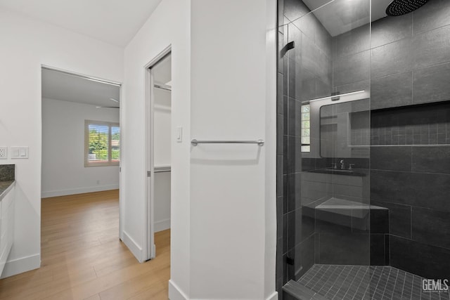 2330 Myrtle St, Bakersfield, CA 93301 - full bathroom featuring wood finished floors, a walk in shower, and baseboards