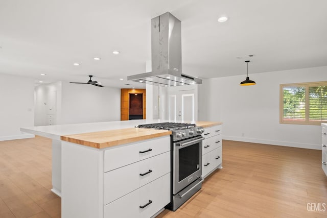 2330 Myrtle St, Bakersfield, CA 93301 - kitchen featuring stainless steel gas range, island exhaust hood, wooden counters, light wood-style flooring, and recessed lighting