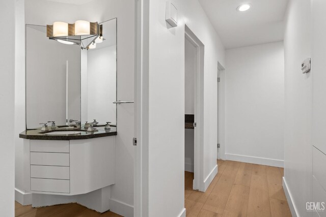 2330 Myrtle St, Bakersfield, CA 93301 - bathroom with wood finished floors, recessed lighting, baseboards, and vanity