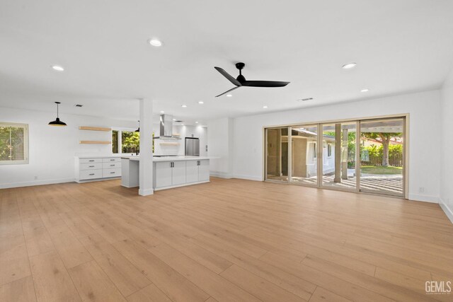 2330 Myrtle St, Bakersfield, CA 93301 - unfurnished living room featuring baseboards, light wood-style flooring, healthy amount of natural light, and recessed lighting