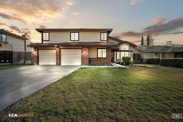 front of property featuring a garage and a yard