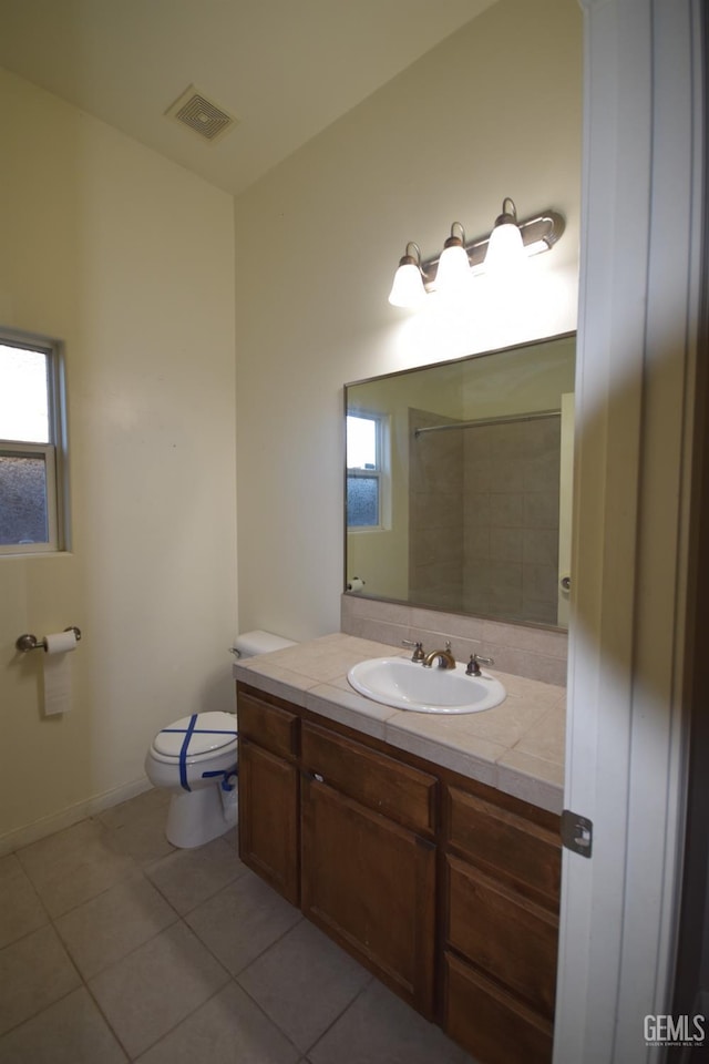 full bath featuring tile patterned flooring, a healthy amount of sunlight, visible vents, and toilet