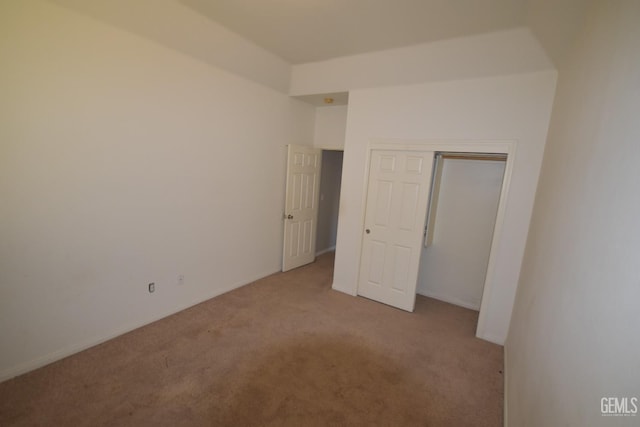 unfurnished bedroom featuring a closet and carpet flooring