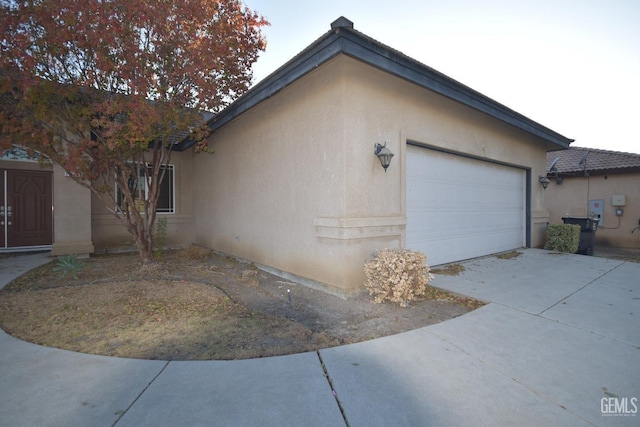 view of home's exterior featuring a garage and stucco siding