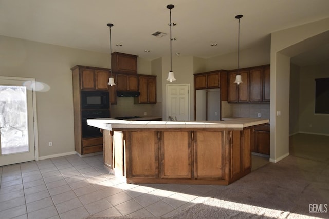 kitchen featuring a large island, visible vents, backsplash, under cabinet range hood, and black appliances