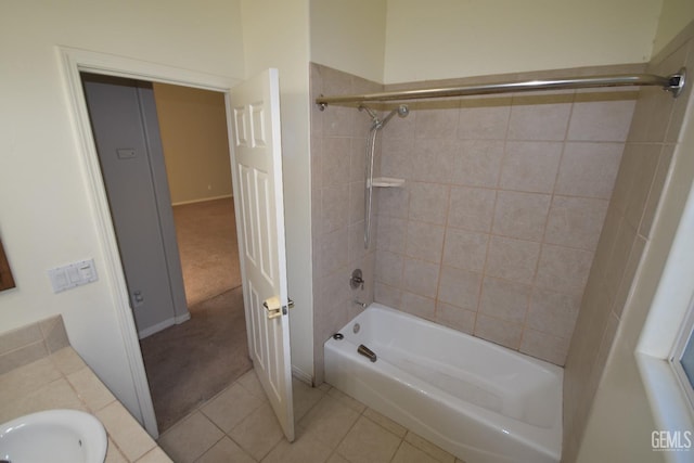 bathroom featuring shower / bath combination, tile patterned flooring, and a sink