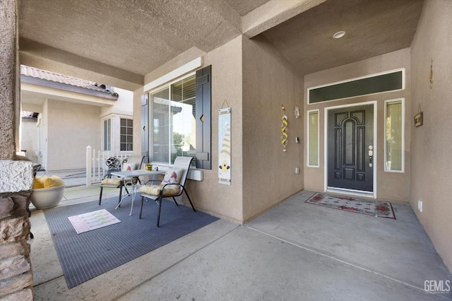 view of exterior entry featuring stucco siding