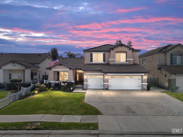 view of front of house with stone siding, a tile roof, an attached garage, fence, and a front lawn