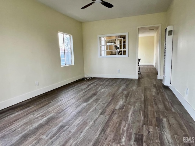 unfurnished room with dark hardwood / wood-style flooring and ceiling fan