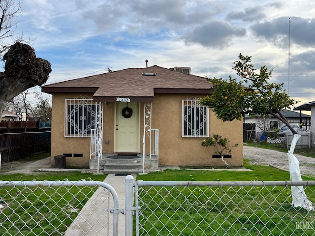 bungalow-style home with a front yard