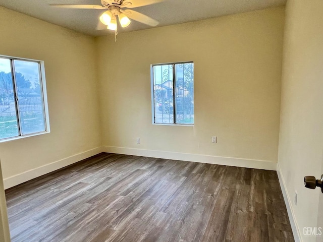 unfurnished room featuring dark hardwood / wood-style floors and ceiling fan