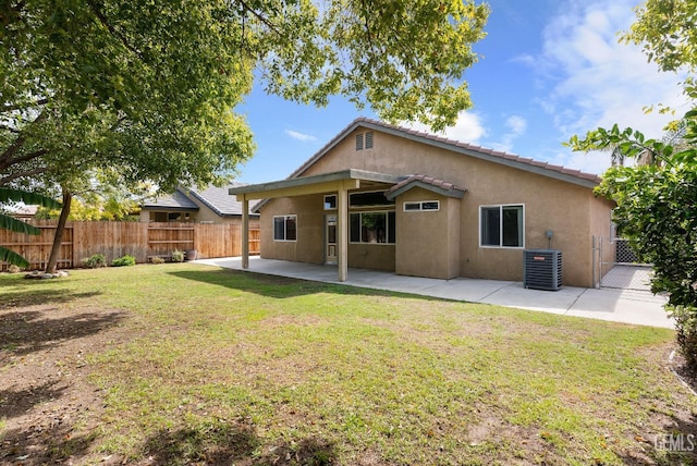 back of house with a patio, fence, stucco siding, central air condition unit, and a lawn