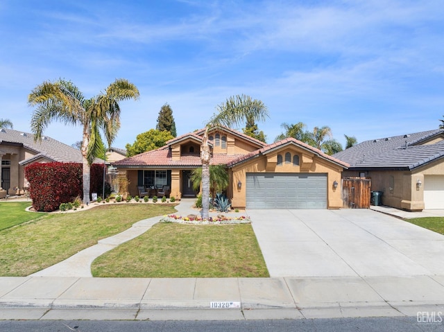 view of front of home featuring a tiled roof, concrete driveway, a front yard, stucco siding, and a garage