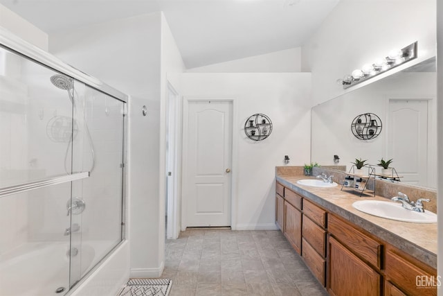 full bathroom with a sink, shower / bath combination with glass door, double vanity, and vaulted ceiling