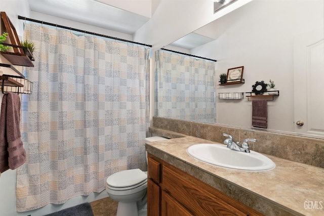 bathroom featuring a shower with curtain, toilet, and vanity