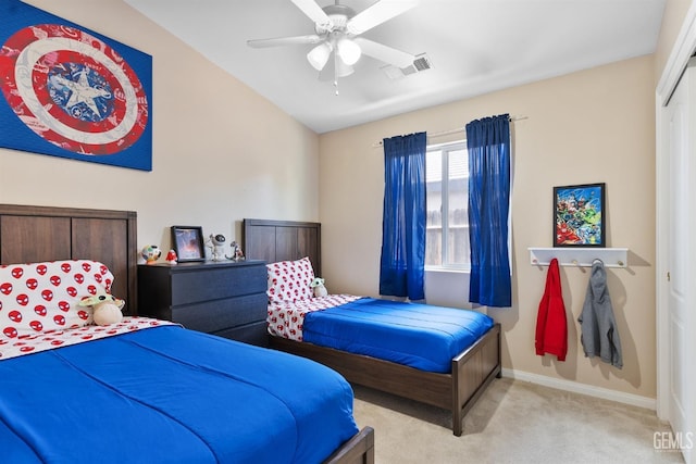 carpeted bedroom featuring a ceiling fan, vaulted ceiling, baseboards, and visible vents