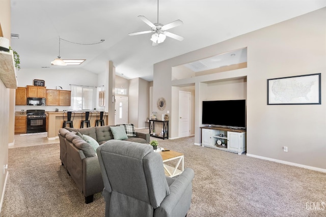 living area featuring a ceiling fan, baseboards, visible vents, vaulted ceiling, and light colored carpet