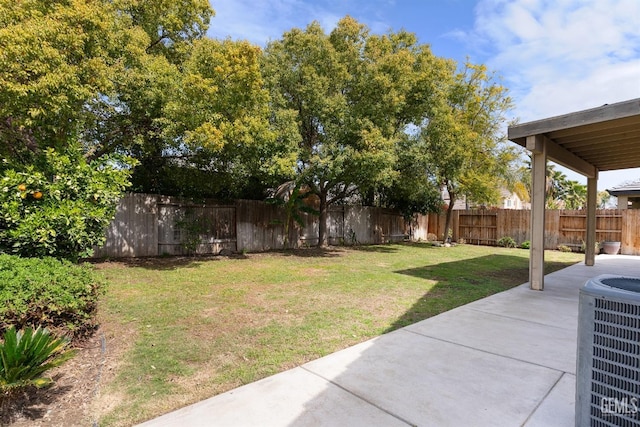 view of yard featuring central air condition unit, a fenced backyard, and a patio area