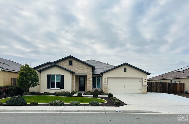 view of front facade featuring a front yard and a garage