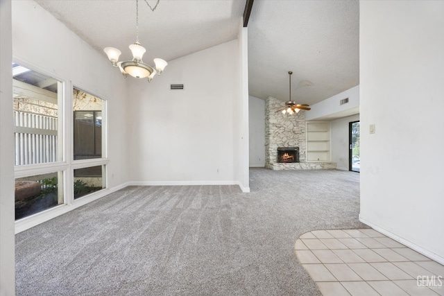 unfurnished living room featuring a textured ceiling, lofted ceiling, light colored carpet, ceiling fan with notable chandelier, and a fireplace